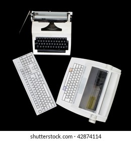 Two  white typewriters of different generations and computer keyboard on a black background.