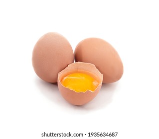 Two whole eggs and one broken isolated on a white background.