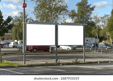 Two wide format posters in the parking lot.