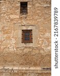 Two windows in an old stone wall at the historic Alamo in San Antonio, Texas.