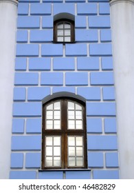 two windows on blue wall