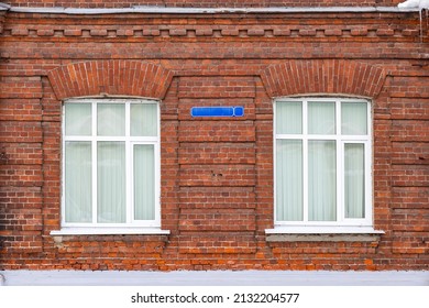 Two windows in the red brick wall