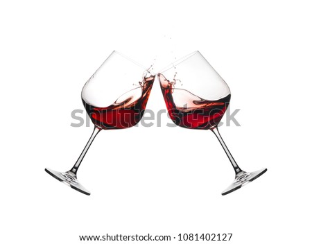 Two wine glasses in toast with splashing isolated on a white background.
