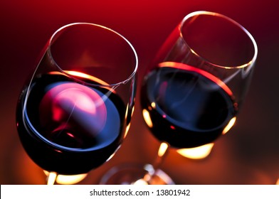 Two Wineglasses With Red Wine At Candlelight