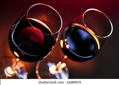 Two Wineglasses With Red Wine At Candlelight