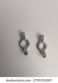Two wing nuts are located side by side on a gray background