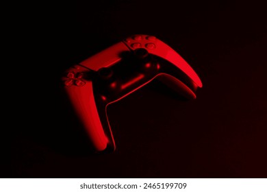 Two wireless game controllers on black background in neon light