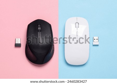 Two Wireless PC mouse with USB flash drives on pink blue  background. Top view. Creative layout