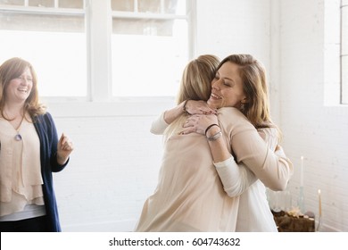 Two Woman Hugging At A Party