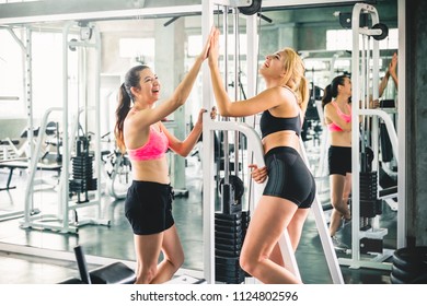 Two Woman With Sportwear, Having Fun At Sport Gym For Workout And Weight Training Concept