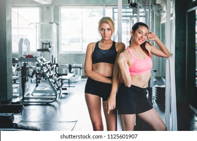 Two Woman With Sportwear, Having Fun At Sport Gym For Workout And Weight Training Concept