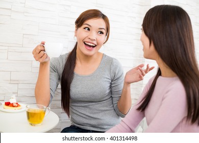 Two Woman Talking To Each Other Inside Coffee Shop