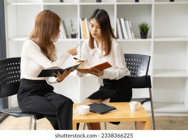 Two woman talking together, Creative female executives meeting in the office - Shutterstock ID 2338366225
