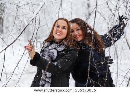 Two woman in winter forest