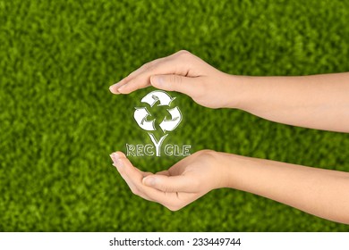 Two Woman's open hands making a protection gesture holding recycle sign  isolated on green background.Concept protect nature,recycle. - Shutterstock ID 233449744