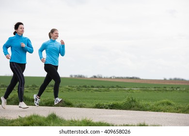 Two Women, 40 And 20 Years Old, Jogging (running) Outdoors