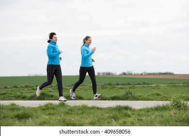Two Women, 40 And 20 Years Old, Jogging (running) Outdoors