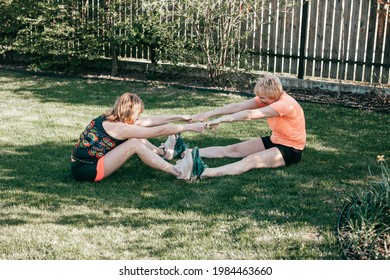 Two Women 55-59 Years Communicate In Nature On Green Grass Go In For Sports