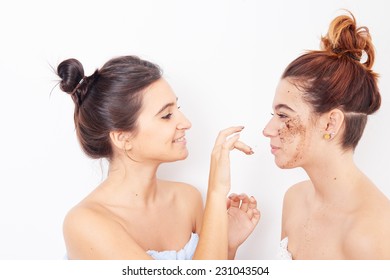 two women applying exfoliating
