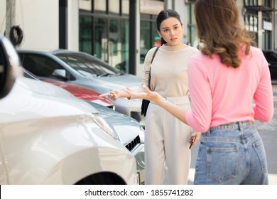 Two Women Arguing At Car Accident Site 