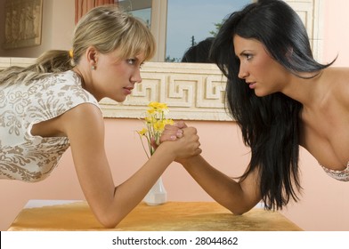 Two Women Arm Wrestling At Work On Desk On White Background