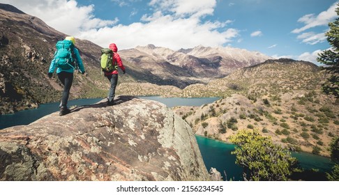 Two Women Backpackers Hiking  In Beautiful Winter Mountains