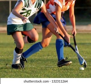 Two women battle for control of ball during field hockey game