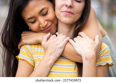 Two Women Best Friends Hugging And Embracing With Close Up And Focus On Hands - Caucasian And Asian Women Together In Barcelona, Friendship, Multicultural City And Love