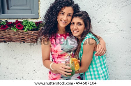 Similar – Happy women looking at camera over garden fence