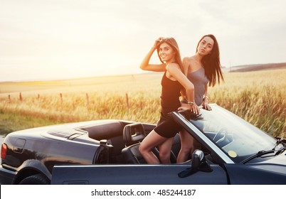 Two Women In A Black Car On The Roadside Roads