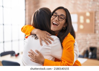 Two Women Business Workers Hugging Each Other At Office