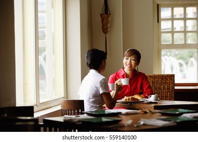 Two Women At Cafe, Having Coffee