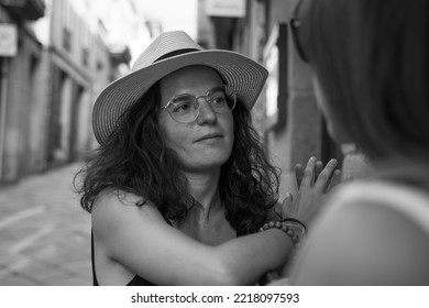 Two Women Chatting And Laughing Outside A Bar In Spain