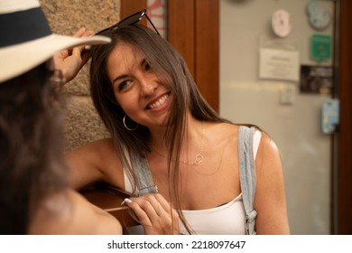 Two Women Chatting And Laughing Outside A Bar In Spain