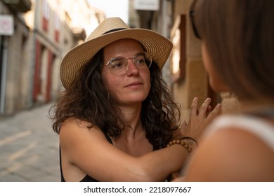 Two Women Chatting And Laughing Outside A Bar In Spain