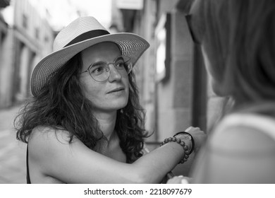 Two Women Chatting And Laughing Outside A Bar In Spain