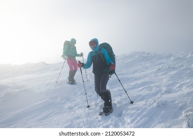 Two Women Climbed To The Top Of The Mountain During A Fog, Winter Trekking, Two Girlfriends Travel Together, Snow-capped Mountains, Snowstorm