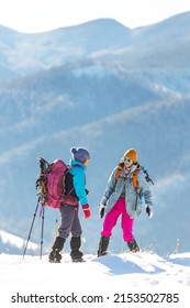 Two Women Climbed To The Top Of The Mountain During A Winter Hike, Winter Trekking, Two Girlfriends Travel Together, Snow-capped Mountains