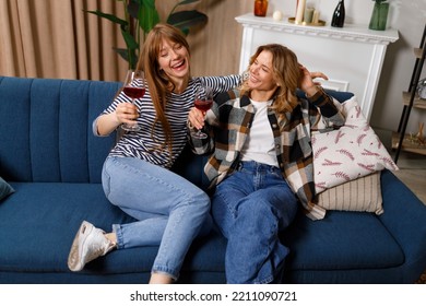 Two Women Of Different Ages Drinking Wine And Having Fun While Sitting On The Sofa