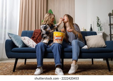 Two Women Of Different Ages Hanging Out Together And Sharing Popcorn