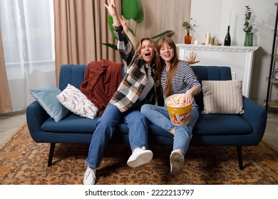 Two Women Of Different Ages Having Loud Fun While Watching A Movie At Home On The Couch