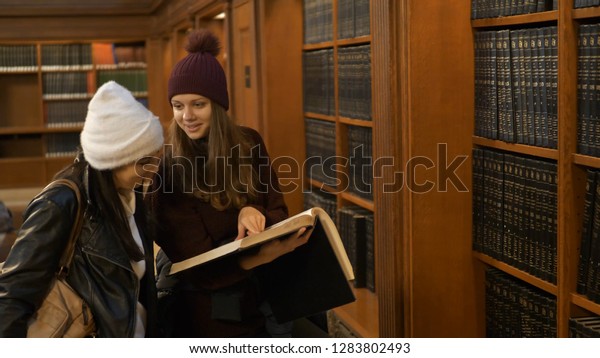 Two women doing research in a library - NEW YORK /\
USA - DECEMBER 4, 2018