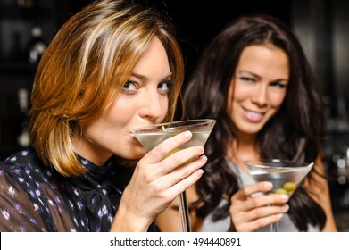 Two Women Drinking Martinis In Bar