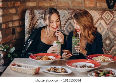 Two Women Eating Pasta In An Italian Restaurant