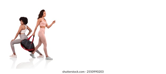 Two women engage in a workout session, one performing a lunging exercise while the other walks confidently with a gym bag. They are dressed in matching activewear in a bright environment. - Powered by Shutterstock