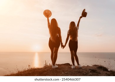 Two Women Enjoying Sunset on a Clifftop - Powered by Shutterstock