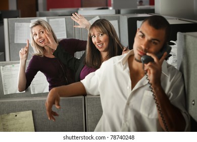 Two Women Flirting With A Male Coworker In The Office