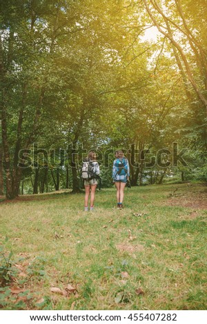 Similar – Women friends laughing while walking in forest