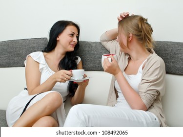 Two Women Friends Chatting Over Coffee At Home