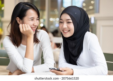 Two Women, Friends With Different Culture, Sharing And Enjoying The Same Streaming Service, Concept Of Friendship Across Ethnicity